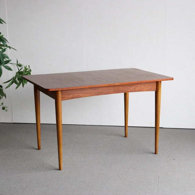 Mid-century British vintage teak dining table with rectangular top, smooth wood grain, and tapered legs from Denmark design.