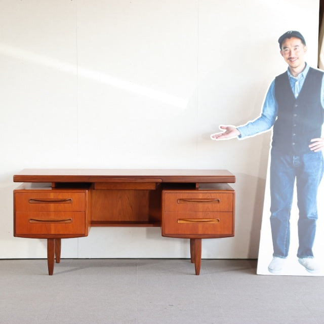 Vintage teak G-PLAN mid-century desk with clean lines, tapered legs, and six spacious drawers, British design.