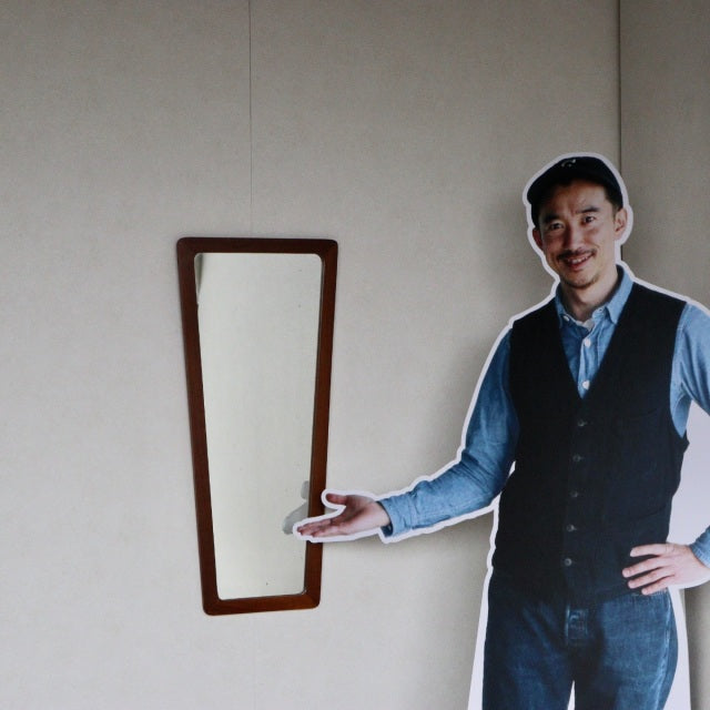 Vintage British mid-century teak trapezoid wall mirror with clean lines and visible wood grain.