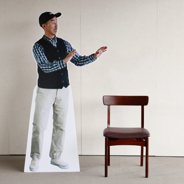 Vintage teak dining chair with dark wood grain, mid-century British design from Denmark, straight legs, curved backrest.