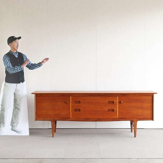 Vintage teak mid-century sideboard by YOUNGER with clean lines, tapered legs, and rich wood grain from British-Danish design.