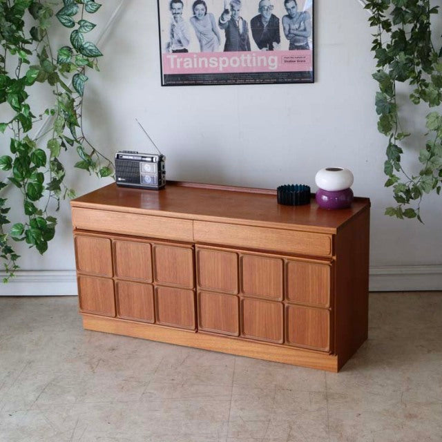 Vintage British mid-century teak McIntosh sideboard with geometric panel doors and tapered legs.