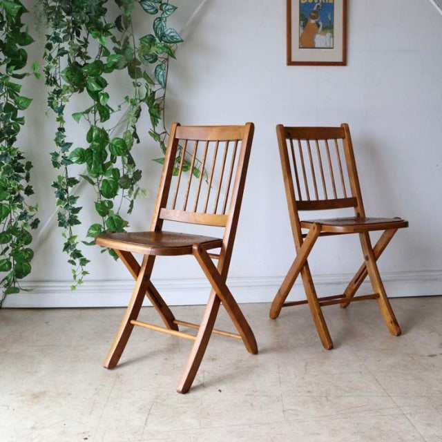 Pair of vintage teak folding chairs with slatted backs, slender legs, mid-century British and Danish design accents,.