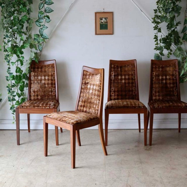 Set of four vintage British G-Plan teak dining chairs with mid-century Denmark design, featuring woven seats and clean wood.
