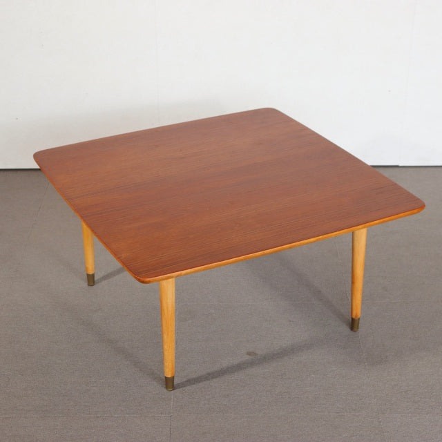 Vintage mid-century teak coffee table with square top, tapered British-style legs, and smooth wood grain from Denmark.