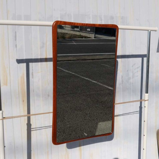 Mid-century British vintage teak wall mirror with rounded corners, rich wood grain, and sleek rectangular shape.