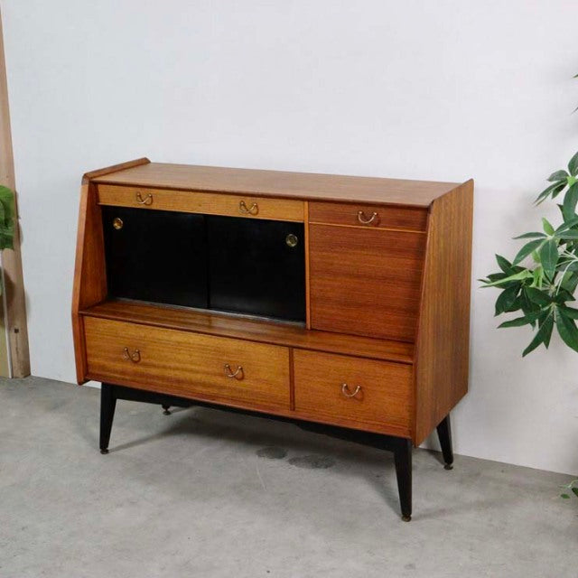 Vintage teak G-Plan mid-century highboard with black sliding doors, brass handles, and tapered black legs.