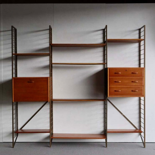 Vintage teak Ladderax unit shelf by Staples, British mid-century design with open shelves and drawers, visible wood grain,.