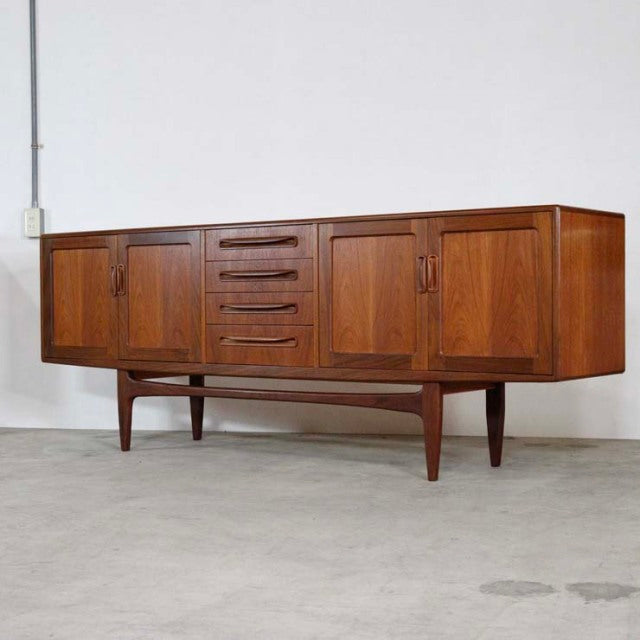 Vintage British mid-century teak sideboard by G-Plan with four drawers, two cabinets, and tapered legs.