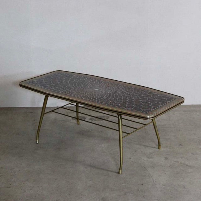 Mid-century British teak coffee table with patterned tile top, tapered legs, and lower metal rack in vintage Denmark style.