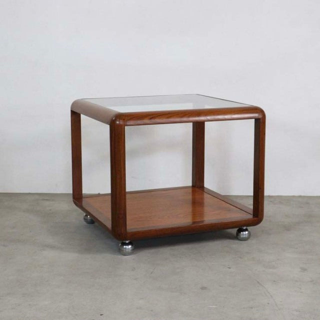 Vintage British mid-century G-Plan teak cube coffee table with rounded edges, glass top, and casters.