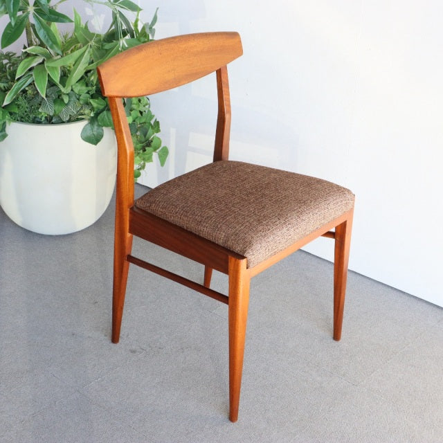 Vintage teak McIntosh mid-century Danish dining chair with smooth wood grain, curved backrest, and brown upholstered seat.