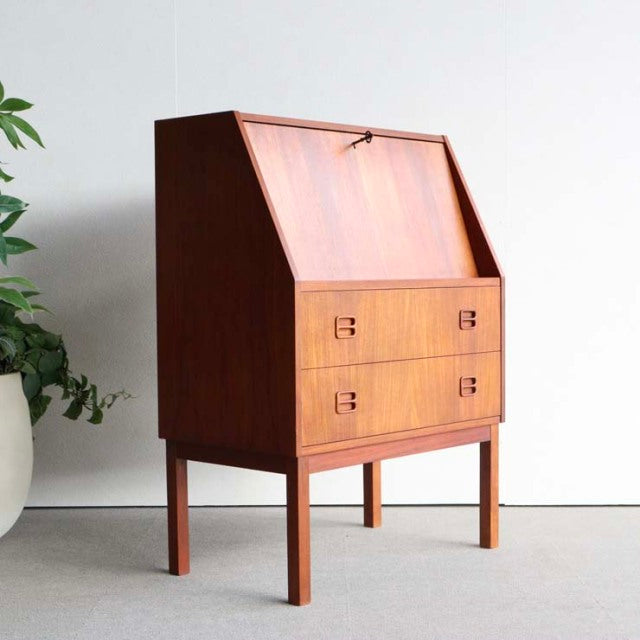 Vintage mid-century Danish teak bureau by Gunnar Nielsen Tibergaard with clean lines, angled drop-front, and tapered legs.