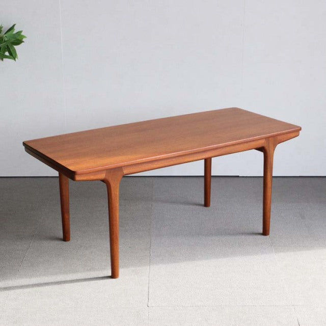 Mid-century British teak coffee table by McIntosh with smooth wood grain and tapered legs.
