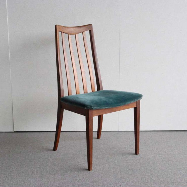 Mid-century British G-Plan dining chair with teak frame, curved slatted back, and teal velvet seat cushion.