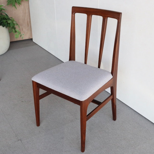 Vintage mid-century Younger Fonseca dining chair in teak with a light gray upholstered seat, slender tapered legs, and a.