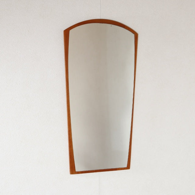 Mid-century vintage teak wall mirror with arched top and tapered rectangular frame, Danish design.