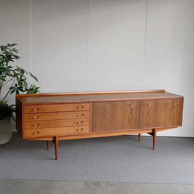 Mid-century British vintage teak sideboard by Robert Heritage for Archie Shine, featuring four drawers with round wooden.