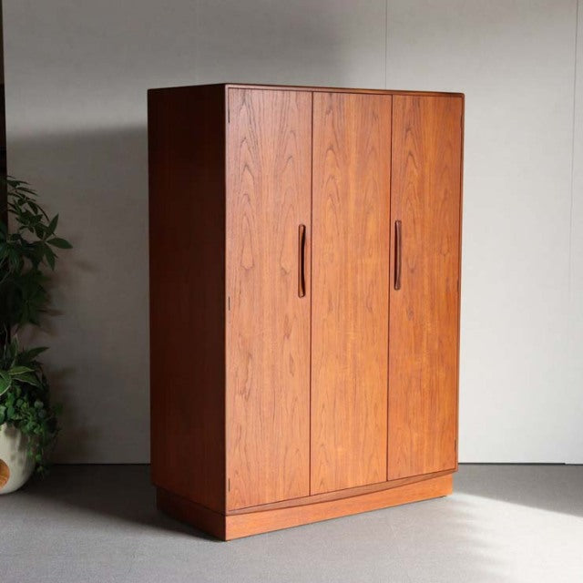 British mid-century G-Plan wardrobe in vintage teak with vertical wood grain and integrated handles.