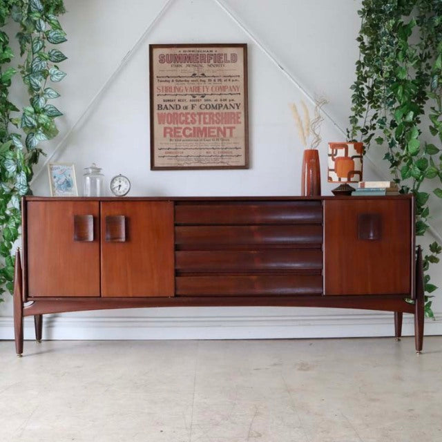 Mid-century British vintage teak sideboard by Elliotts of Newbury with rich wood grain, central drawers, and tapered legs.