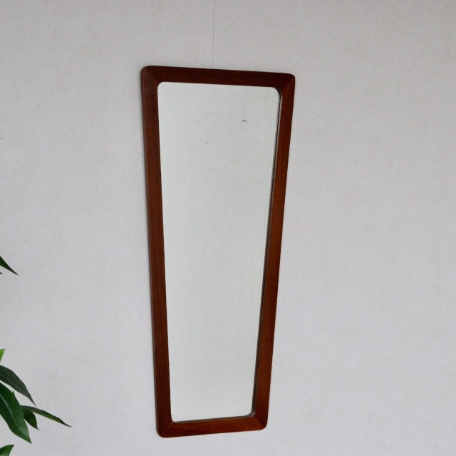 Vintage British mid-century teak trapezoid wall mirror with sleek wood grain frame and clean lines.
