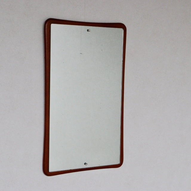 Vintage British mid-century wall mirror with teak frame and gently curved corners, showing fine wood grain and smooth finish.