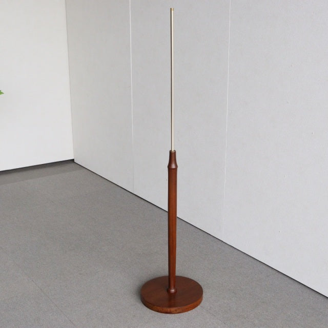 Mid-century British vintage teak floor lamp with slim wooden base and tall slender metal rod stem.