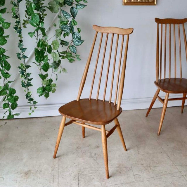 Vintage British mid-century Ercol Goldsmith high-back dining chair in natural teak with slender spindle back and tapered legs.