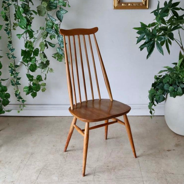 Vintage British Ercol Goldsmith mid-century teak dining chair with slender spindle back and tapered legs.