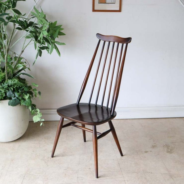 Vintage British mid-century teak dining chair with high spindle back and tapered legs.