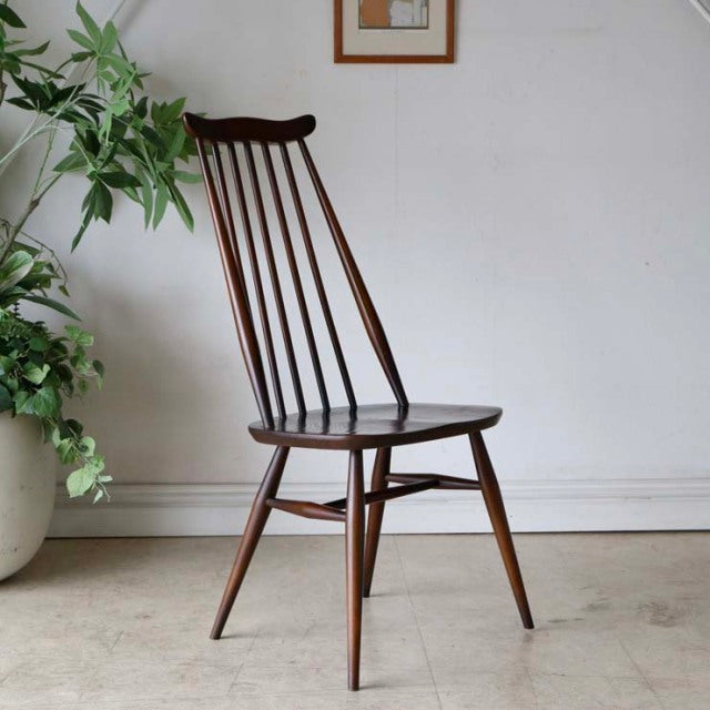 Vintage British mid-century teak dining chair by Ercol with slender spindle back and tapered legs.