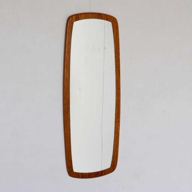 Vintage mid-century British teak wall mirror with elongated rectangular shape and rounded corners, showcasing rich wood.