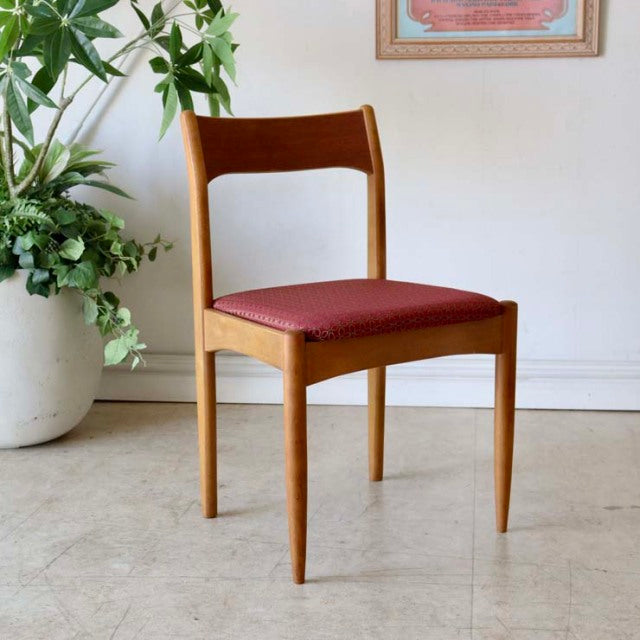 Vintage mid-century British teak dining chair with clean lines, tapered legs, and red floral upholstered seat from Denmark.