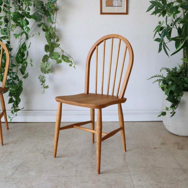 Mid-century British vintage Ercol hoop-back dining chair in teak with curved spindle back and tapered legs.