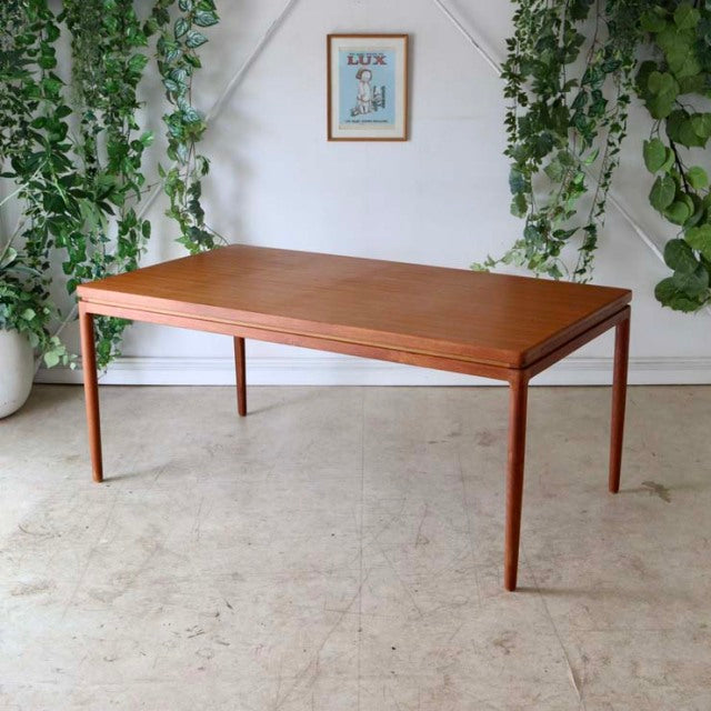 Mid-century vintage teak dining table by Johannes Andersen, British-Denmark style with clean wood grain and slender tapered.